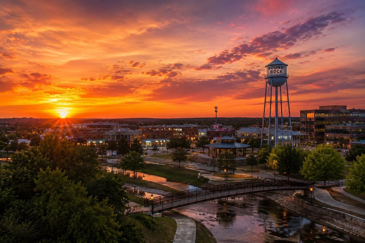 Sunset over downtown Round Rock, Texas — the historic water tower above Brushy Creek