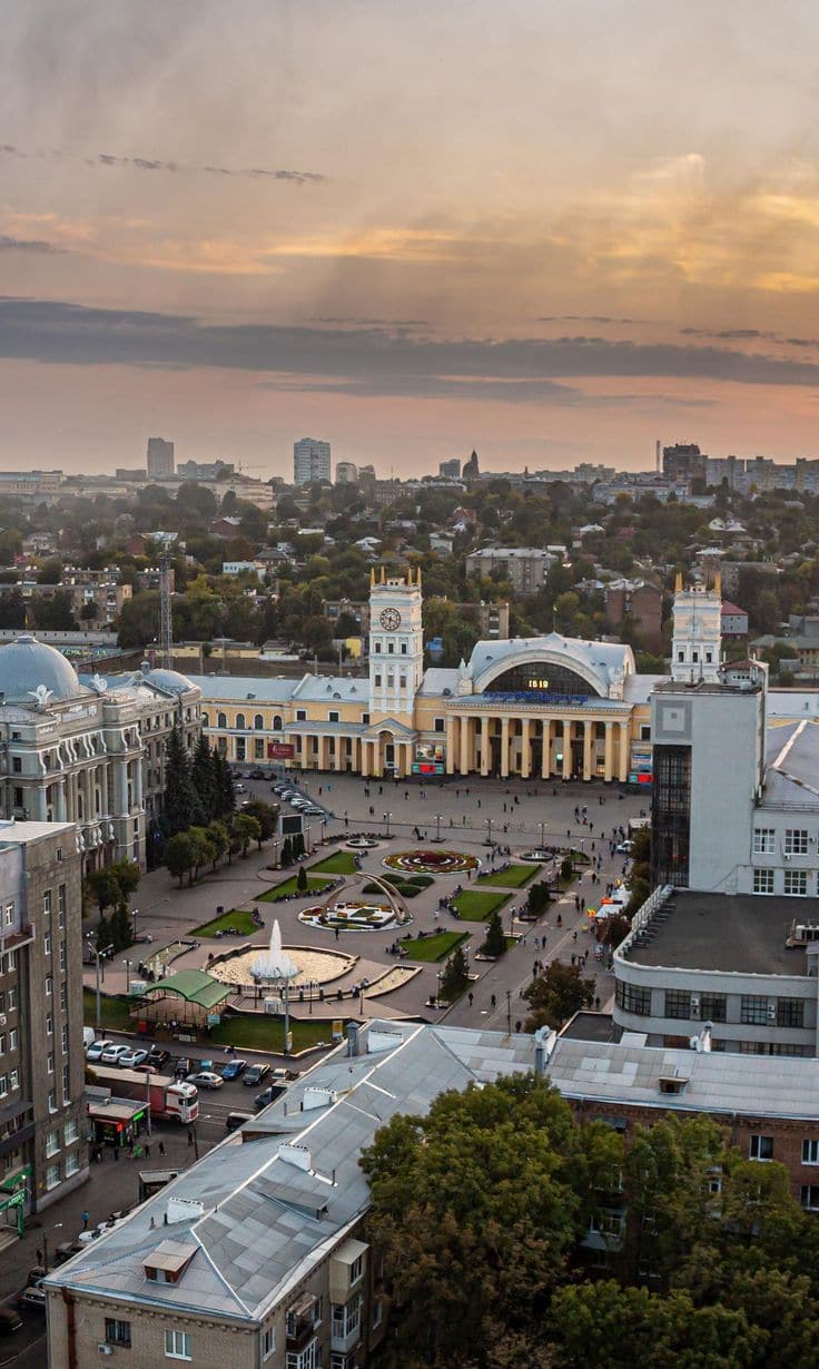 Aerial view of central Kharkiv, Ukraine at sunset — the railway station square with fountains and historic architecture